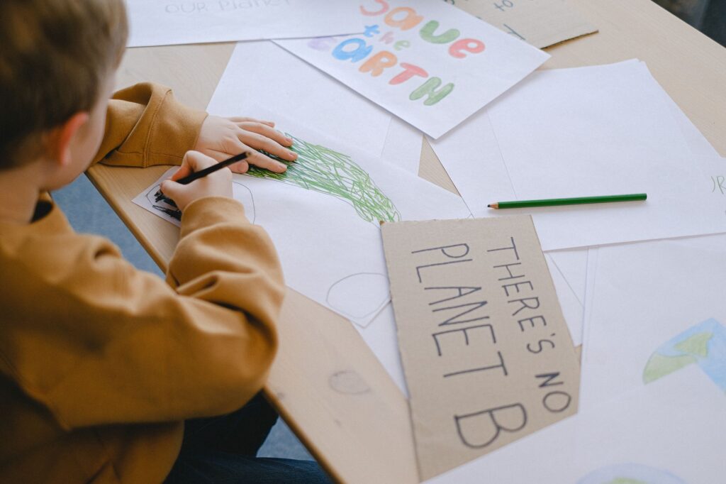 A child creates eco-friendly posters promoting environmental awareness.