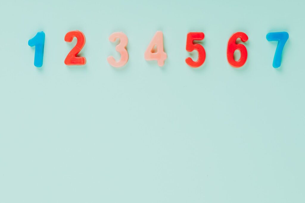 Bright plastic numbers on a blue background with ample copy space, ideal for educational themes.
