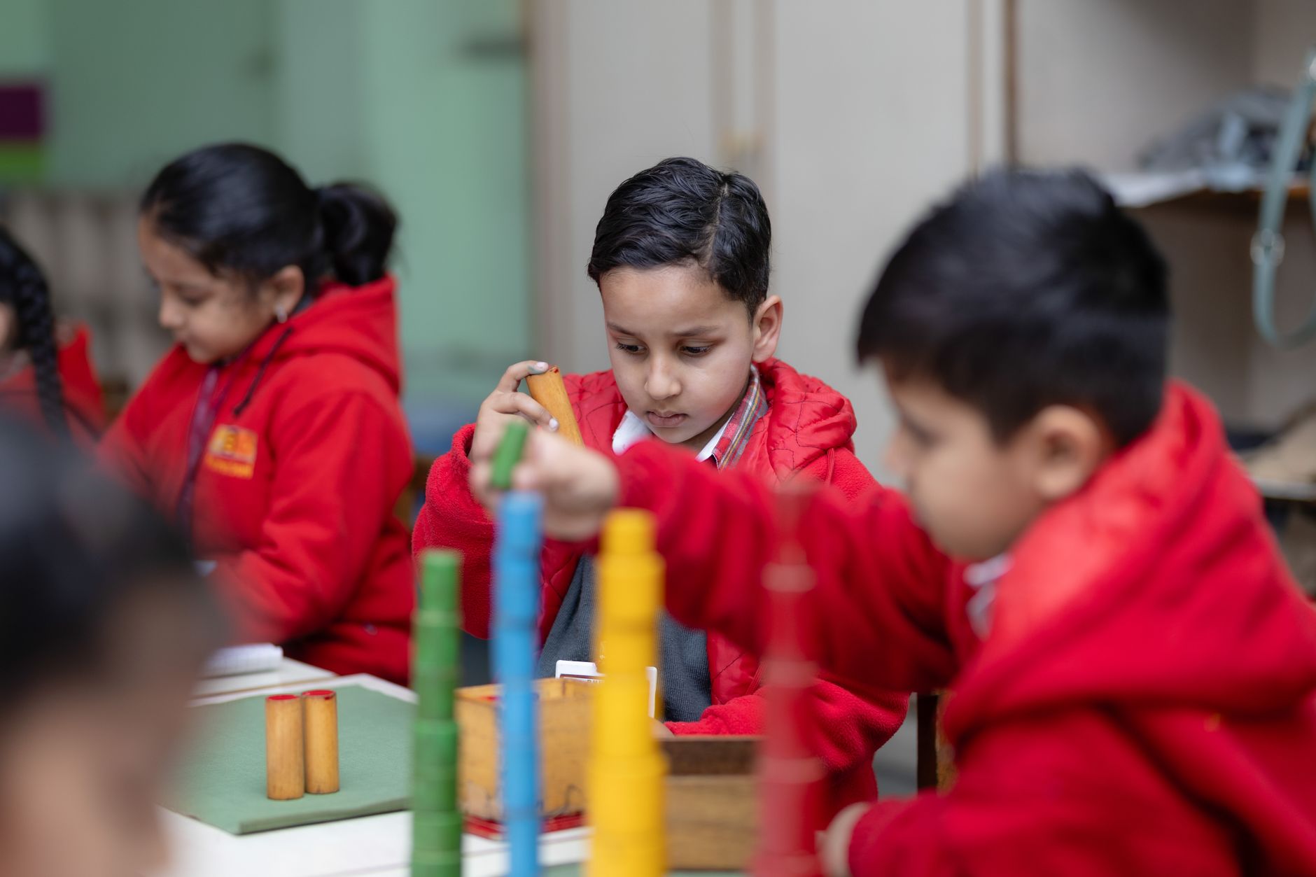 Young children focused on Montessori educational activities, fostering cognitive development.