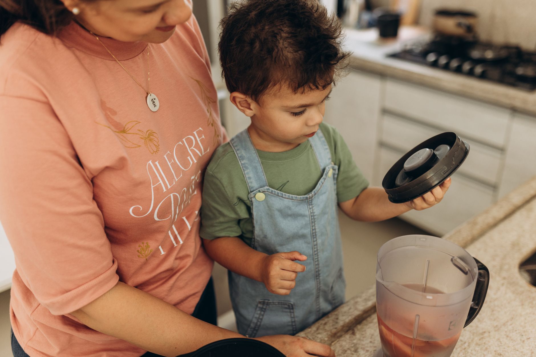 A mother and her child are preparing a homemade meal in their kitchen, fostering family bonding.